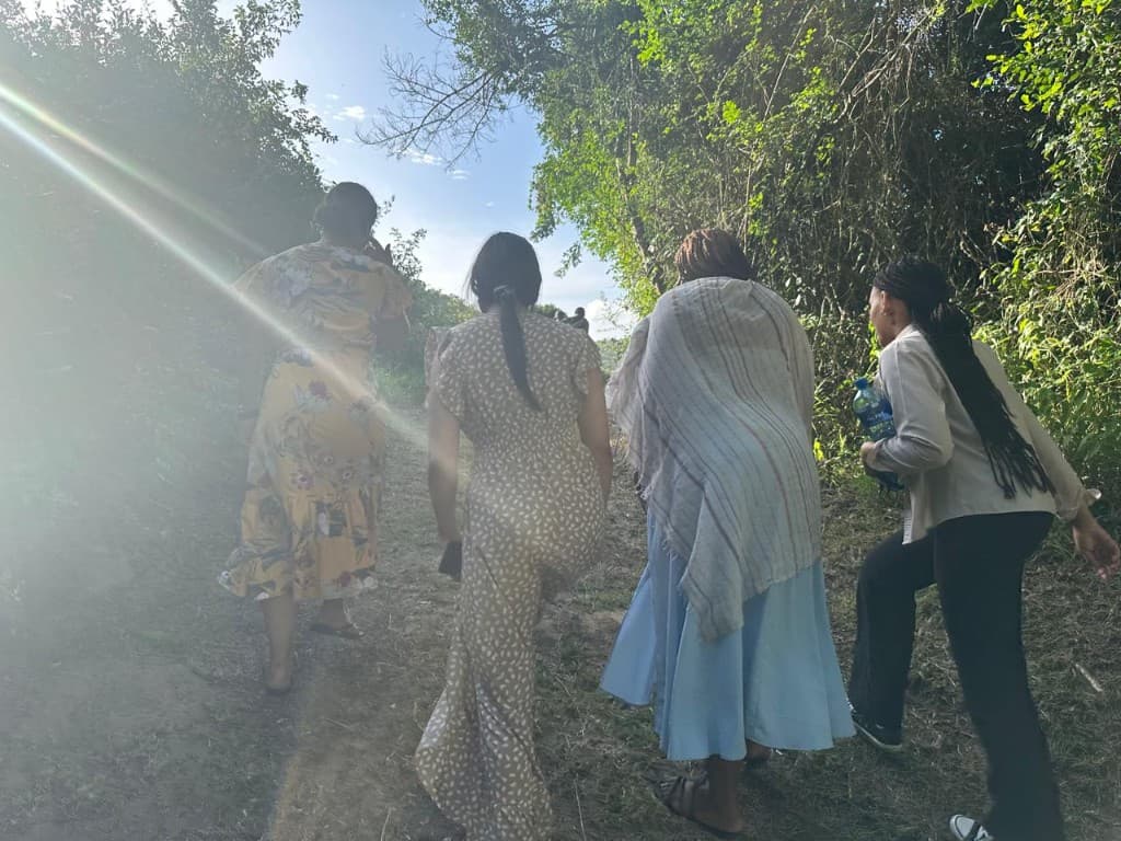 Women walking uphill together in the sunlight